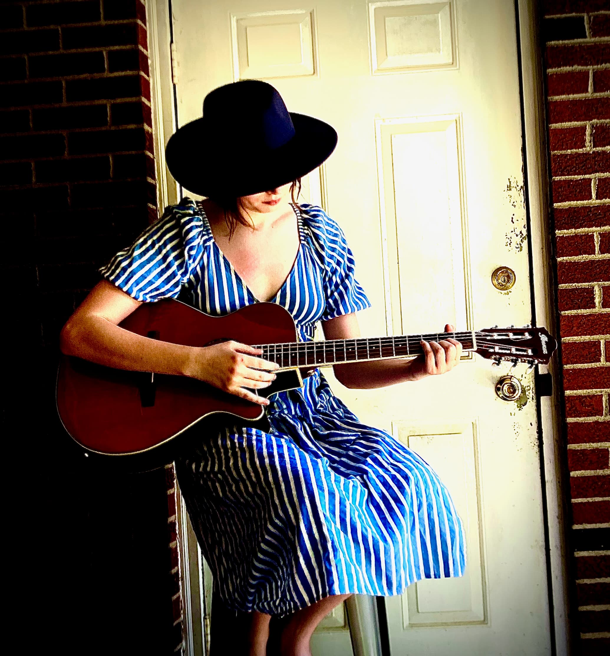 Addison performing with guitar